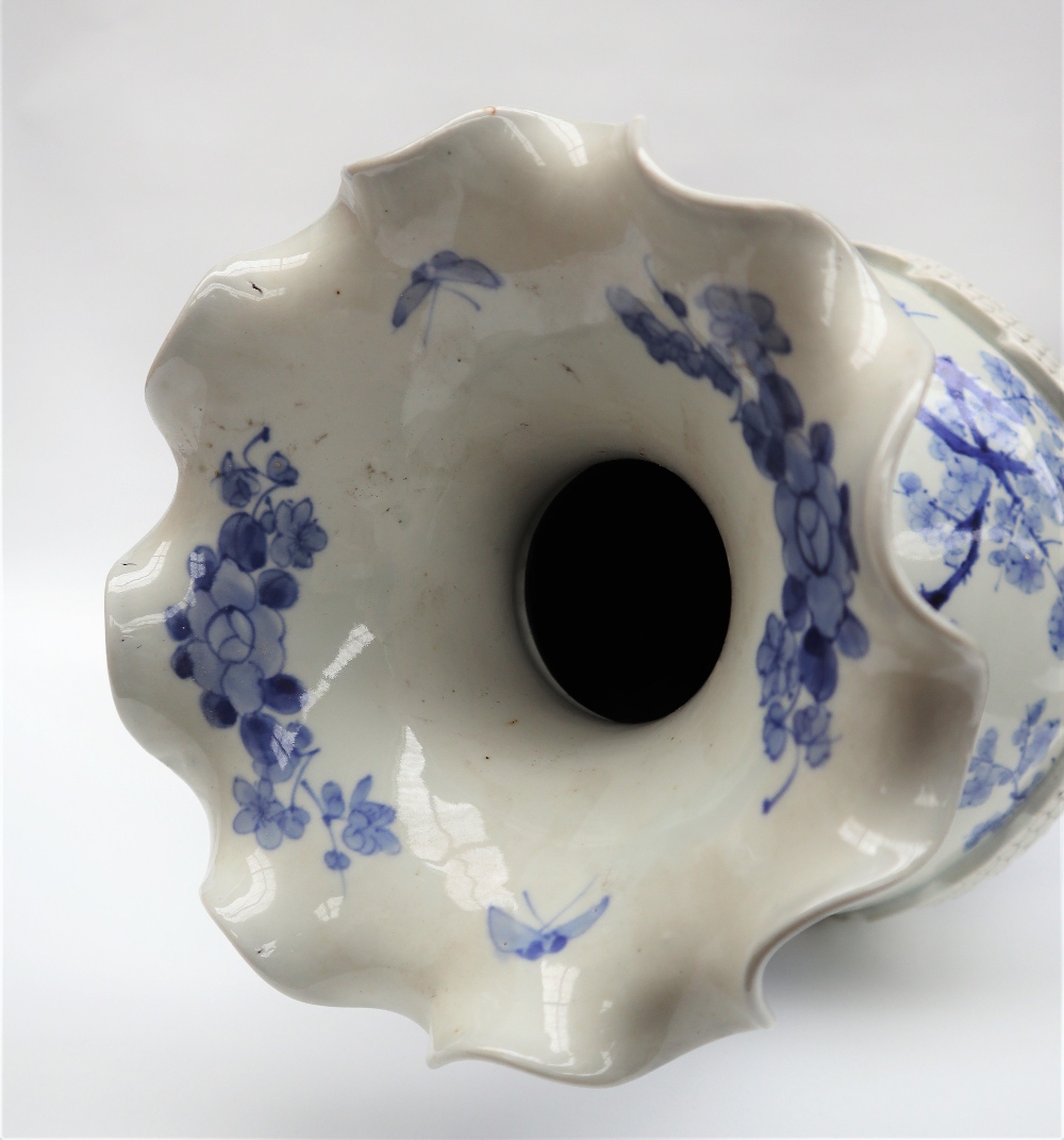 A Japanese blue and white porcelain vase decorated with a raised dragon encircling the vase further - Image 2 of 6