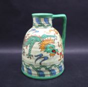 A Charlotte Rhead pottery dragon jug with a cylindrical neck and beehive body, printed,