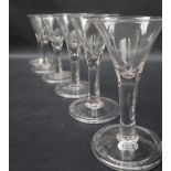 A matched set of six 18th century wine glasses of conical tapering form with tear drop in the stem