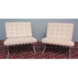 A pair of Barcelona style chrome chairs with white faux leather seat and backs