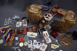 Of military interest - a pair of gilt metal mounted epaulettes together with a collection of cap