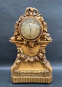 An early 20th century carved pine and gilt gesso mantle clock,