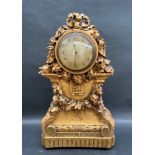 An early 20th century carved pine and gilt gesso mantle clock,