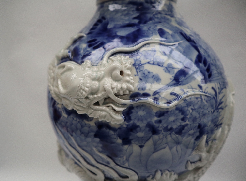 A Japanese blue and white porcelain vase decorated with a raised dragon encircling the vase further - Image 5 of 6
