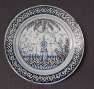 A 19th century Delft plate decorated with a church in a landscape to a lattice border,