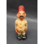 A painted aluminium figure of an Egyptian in a red tarboosh, standing to attention,