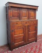 An 18th century oak court cupboard / Didarn with a moulded cornice and turned inverted finials