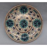 A Chinese porcelain saucer dish, with enamel decoration of flowers and scrolls,