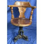A 19th century mahogany Captains chair, with a vase splat and urns,
