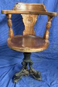 A 19th century mahogany Captains chair, with a vase splat and urns,