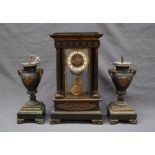 A late 19th century French four glass clock garniture, of architectural form,