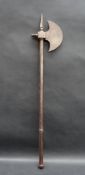 A Persian steel axe with a crescent blade decorated with stylised flowers with a spike to the top