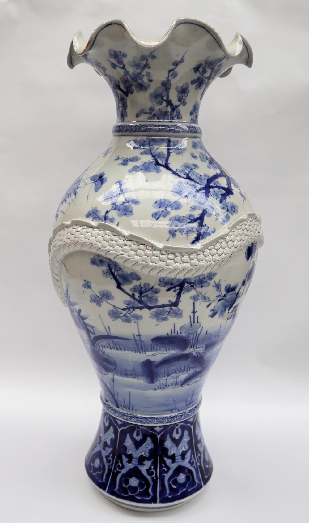 A Japanese blue and white porcelain vase decorated with a raised dragon encircling the vase further - Image 3 of 6