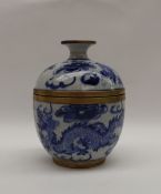 A Chinese pottery blue and white cup and cover, decorated with dragons and clouds,