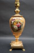 A 19th century porcelain vase converted to a table lamp painted with a spray of garden flowers to