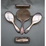 A silver backed hand mirror together with two silver backed hair brushes,