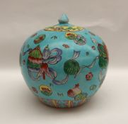 A Chinese porcelain vase and cover of squat form decorated with fish and swags to a turquoise