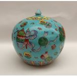 A Chinese porcelain vase and cover of squat form decorated with fish and swags to a turquoise