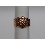 A yellow metal ring of knot form, size 1, marked 14k,