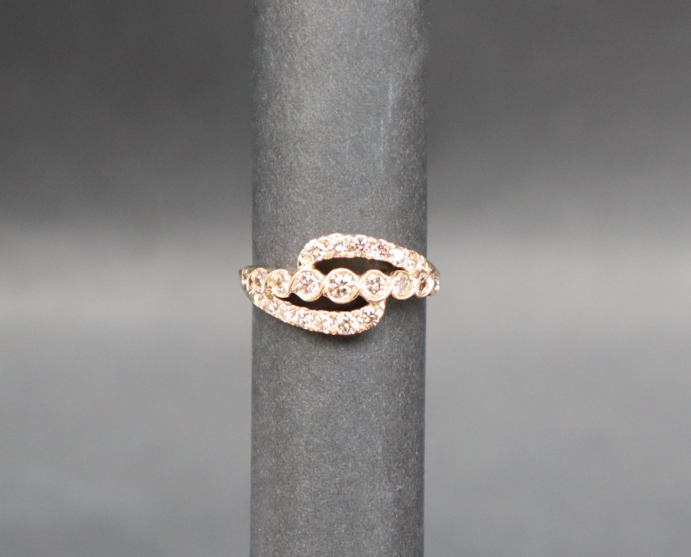 Gemporia - An 18ct gold diamond set ring, of crossover form, totalling 0.