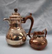 An Elizabeth II silver hot water jug and matching cream jug, of baluster form with ring decoration,