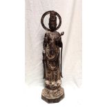 A Japanese cast iron figure of a deity holding a lotus flower on a circular base,