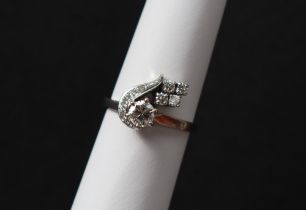 A diamond cluster ring, set with a raised round brilliant cut diamond approximately 0.