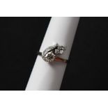 A diamond cluster ring, set with a raised round brilliant cut diamond approximately 0.