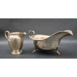 A George V silver sauce boat with a beaded rim and a scrolling handle, Sheffield,