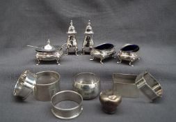 A George V silver five piece cruet set, comprising a mustard pot,