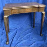 A George III mahogany tea table with a rectangular foldover top on shallow cabriole legs and pad