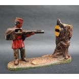 A Creedmoor cast iron money box in the form of a soldier shooting into a tree,