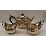 A George V three piece silver tea set, of oval form with line decoration, London, 1919, Harrods Ltd,