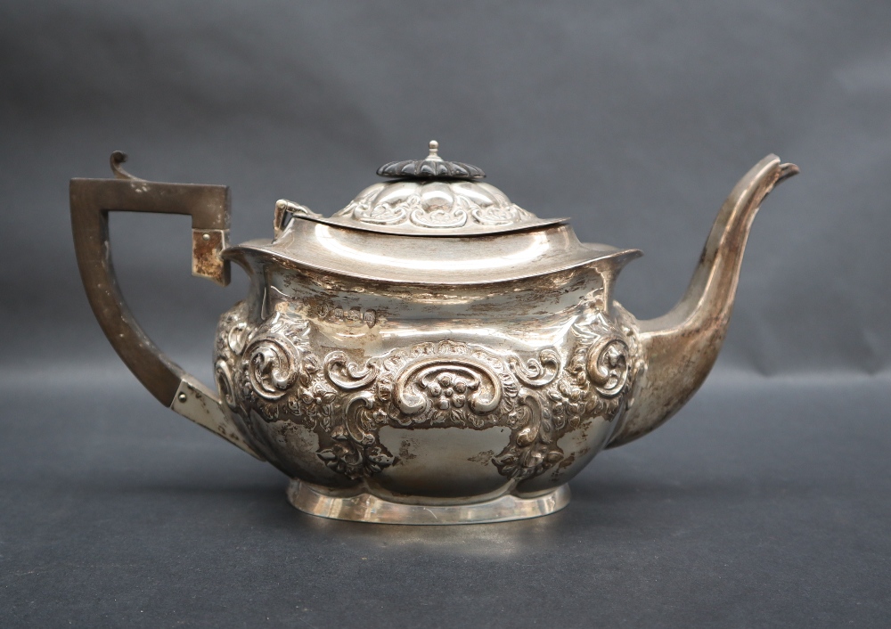An Edward VII silver teapot of oval form embossed with flowers, leaves and scrolls, Birmingham, - Image 2 of 5