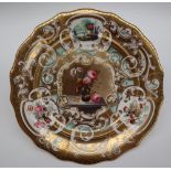 A 19th century English porcelain cabinet plate with a heavily gilt border,