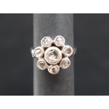 A diamond cluster ring, set with rose cut diamonds to an 18ct gold rub over setting and shank,