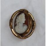 A shell cameo portrait brooch of a maiden in profile in a rotating pinchbeck mount