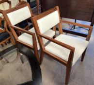 A pair of 20th century teak upholstered elbow chairs