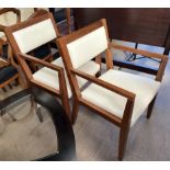 A pair of 20th century teak upholstered elbow chairs