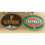 An electrified Caffrey's sign together with a similar Guinness sign