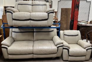 A cream and brown leather three piece suite comprising a three seater settee,