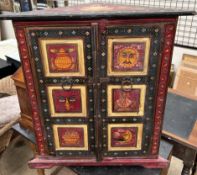 An Indian three corner cabinet, profusely decorated to all sides with figures,