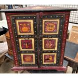 An Indian three corner cabinet, profusely decorated to all sides with figures,