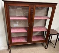 An Edwardian mahogany display cabinet with a pair of glazed doors and glazed sides on cabriole legs