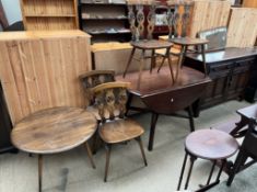 An Ercol sideboard together with a set of four Ercol dining chairs, an Ercol drop leaf dining table,