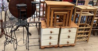 A pair of cream painted pine bedside chests of drawers on bun feet together with a wine rack,