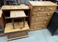 A pine chest of drawers together with a pine bookcase,