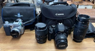 A Canon EOS 600D digital camera together with an 18-55mm lens, a 35-135mm lens and a 70-210mm lens,