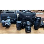 A Canon EOS 600D digital camera together with an 18-55mm lens, a 35-135mm lens and a 70-210mm lens,