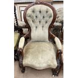 A Victorian walnut framed lady's chair with a carved back rail,